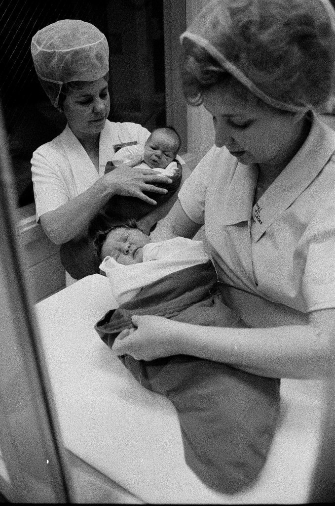 Nurses putting babies in Christmas stockings - Chicago Sun-Times
