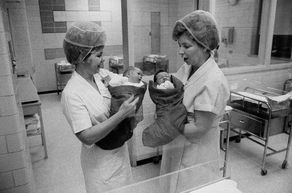Nurses putting babies in Christmas stockings - Chicago Sun-Times