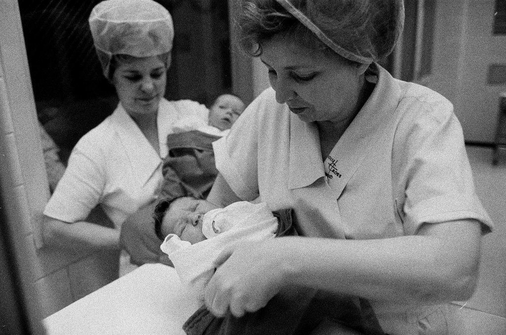 Nurses putting babies in Christmas stockings - Chicago Sun-Times