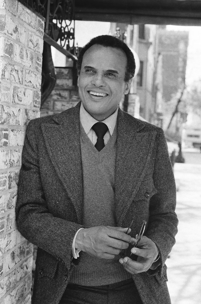 Harry Belafonte holding pair of glasses - Fred Stein for Chicago Daily News