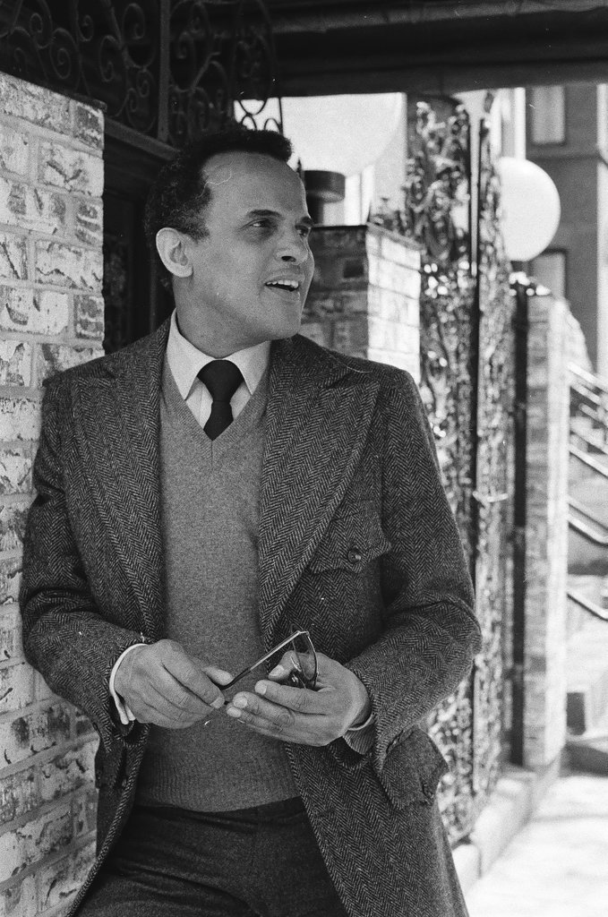 Harry Belafonte holding pair of glasses - Fred Stein for Chicago Daily News