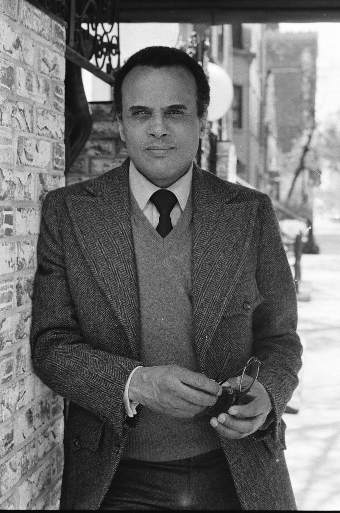 Harry Belafonte holding pair of glasses - Fred Stein for Chicago Daily News