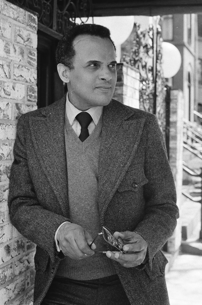 Harry Belafonte holding pair of glasses - Fred Stein for Chicago Daily News