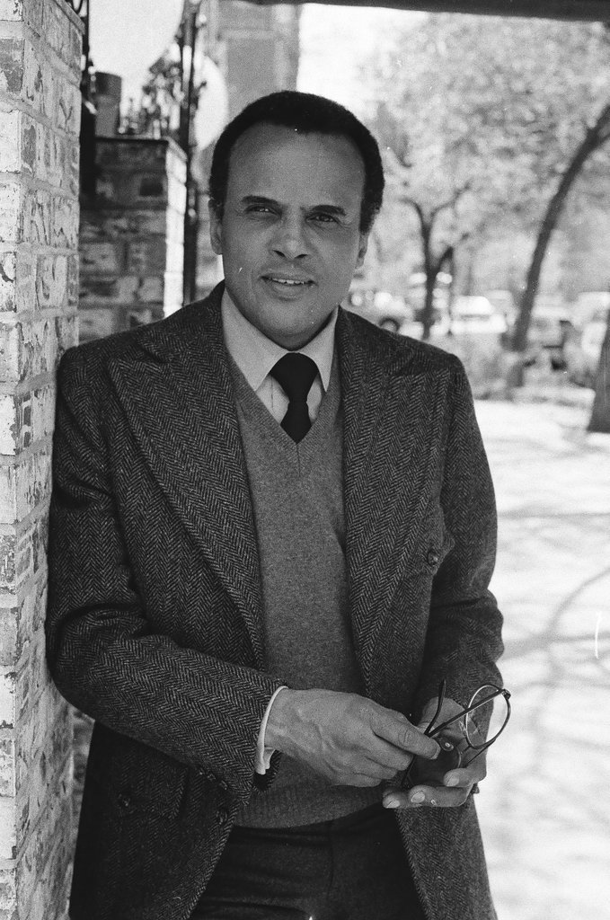 Harry Belafonte holding pair of glasses - Fred Stein for Chicago Daily News