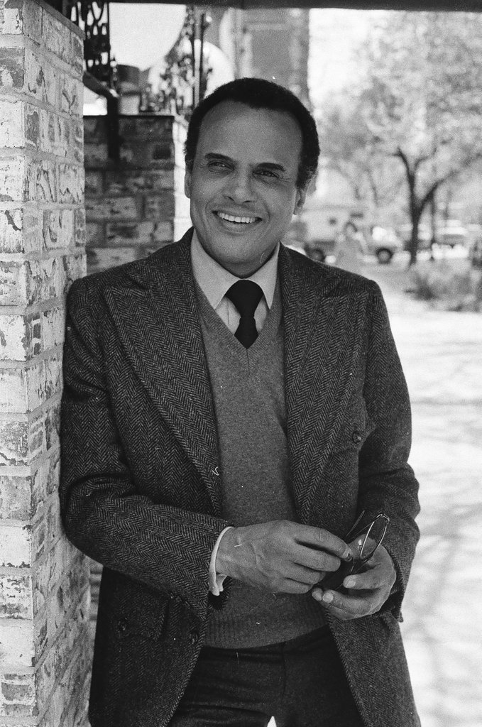 Harry Belafonte holding pair of glasses - Fred Stein for Chicago Daily News