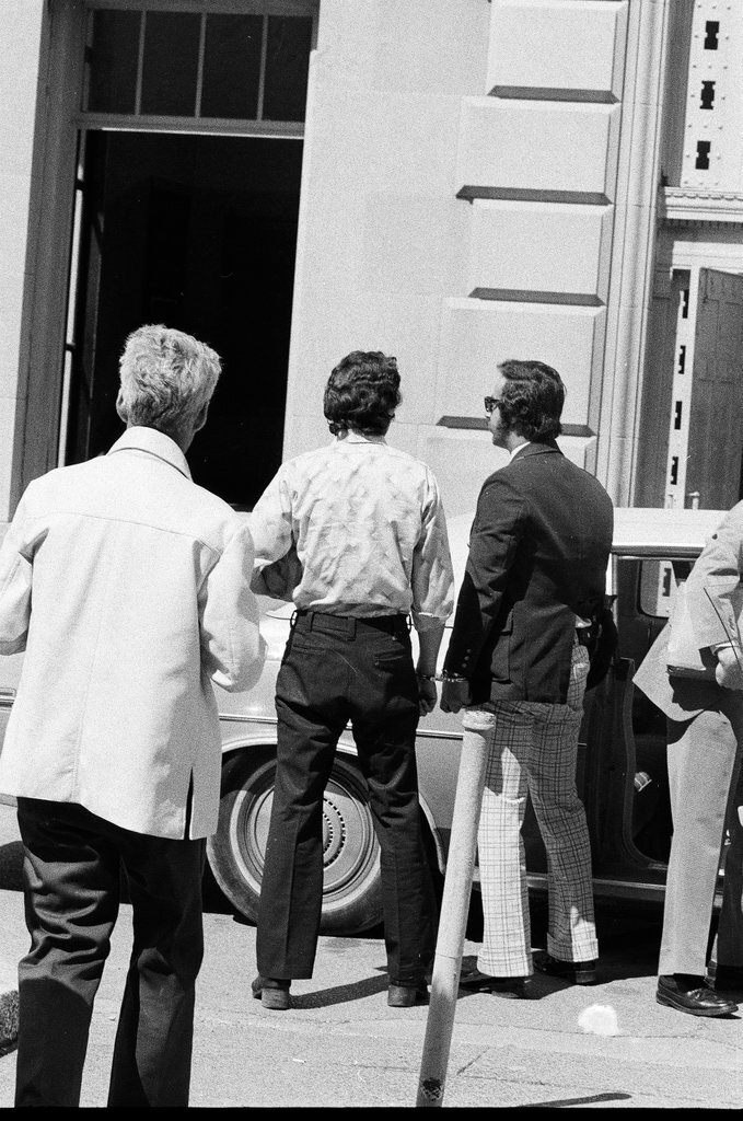 Frank DeLuca led to a car outside of the Criminal Court Building - John H. White for Chicago Sun-Times