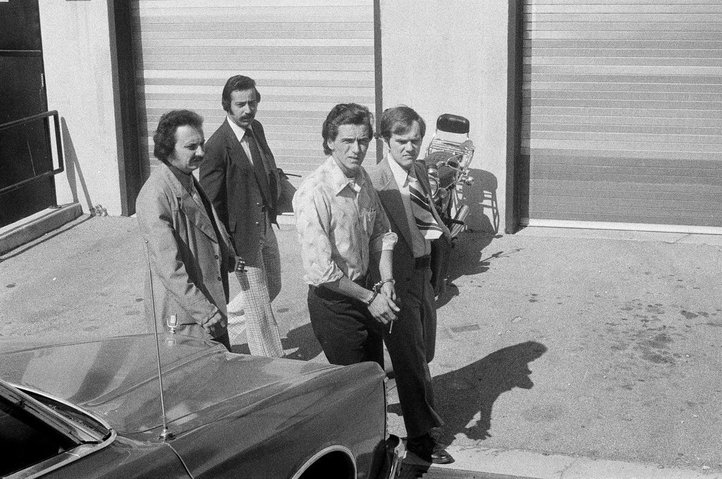 Frank DeLuca led to police car - Charles Krejcsi for Chicago Sun-Times