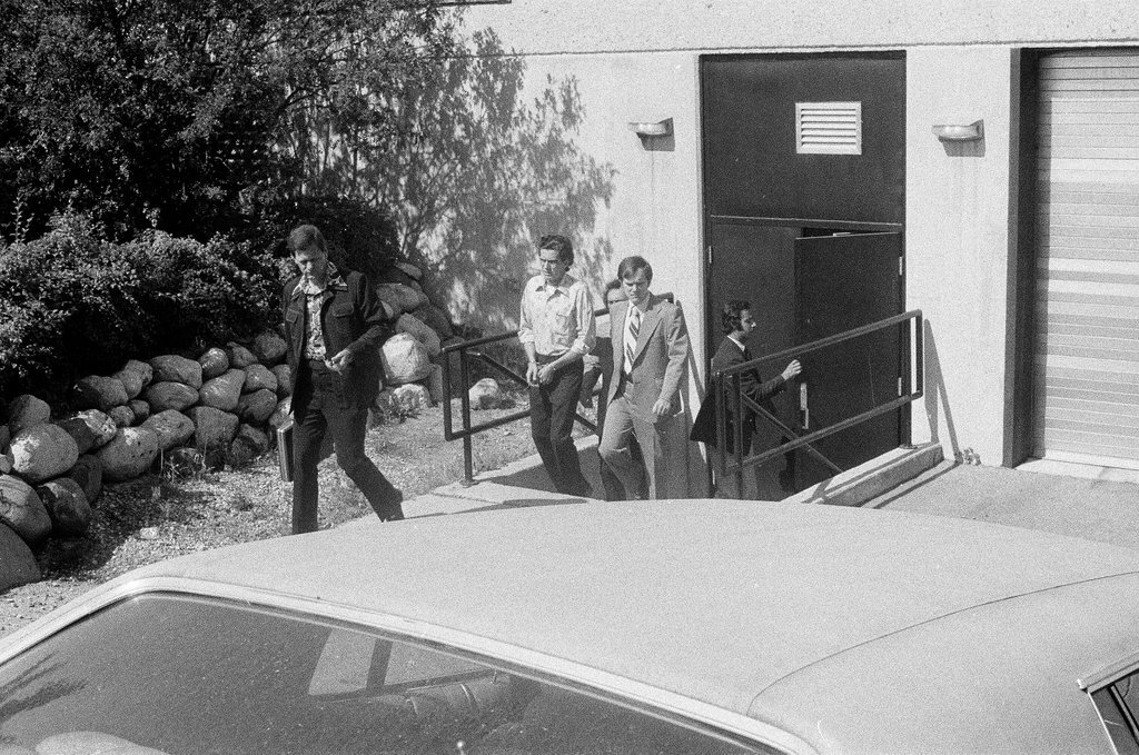 Frank DeLuca led to police car - Charles Krejcsi for Chicago Sun-Times