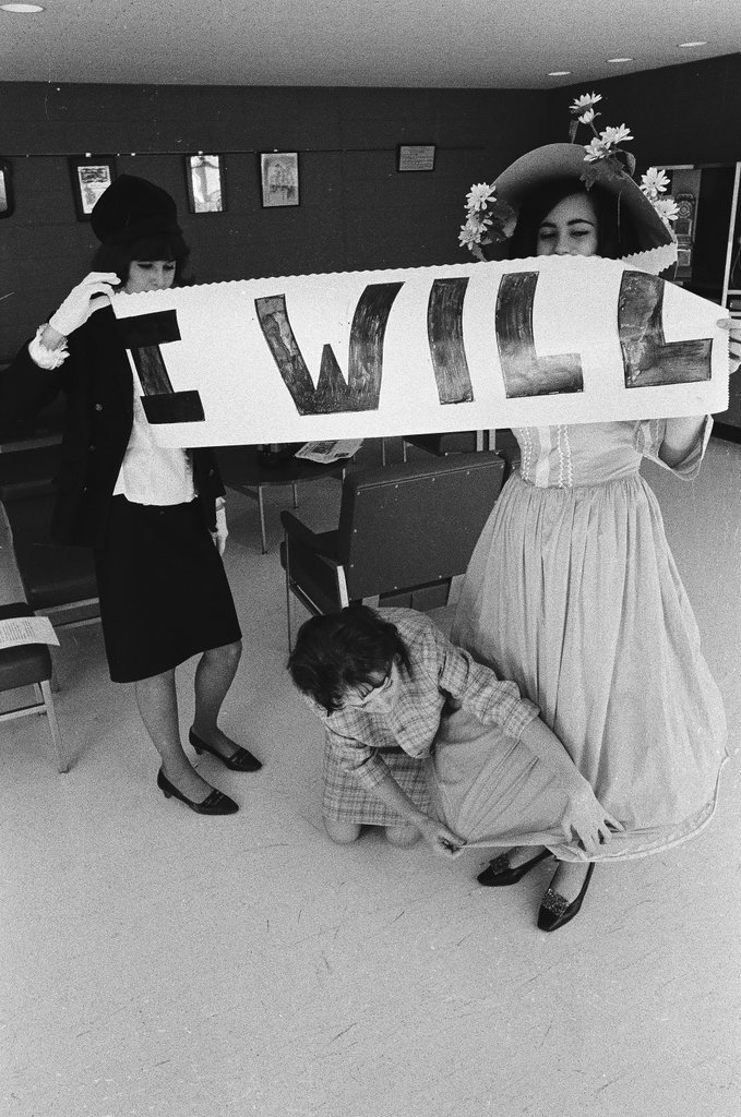 Two students dressed in historical and contemporary costumes holding a banner - Chicago Sun-Times