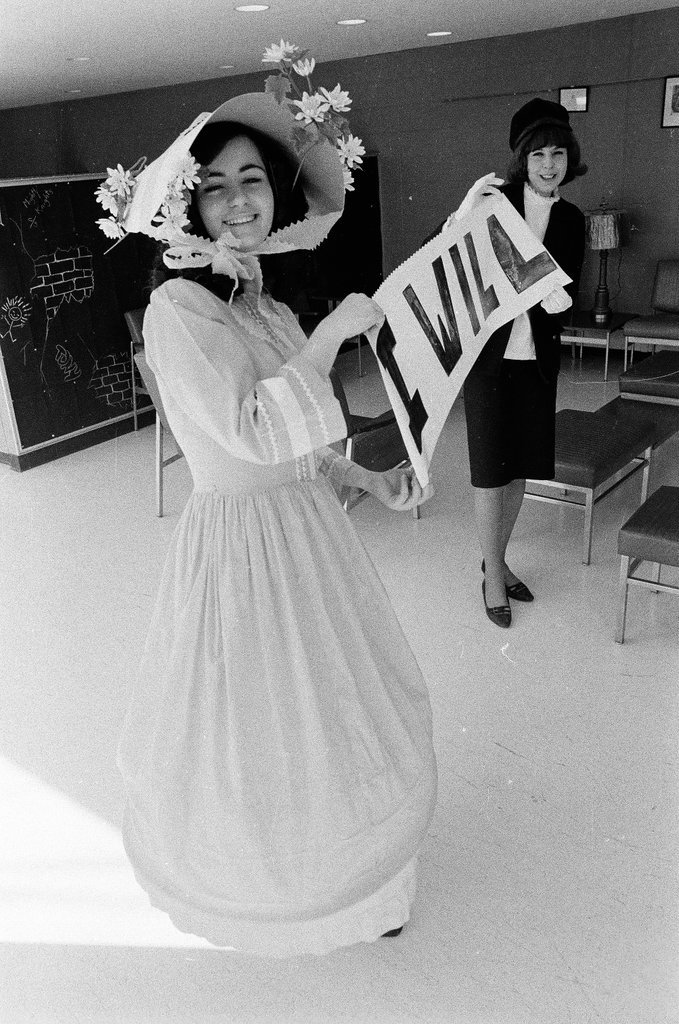 Two students dressed in historical and contemporary costumes holding a banner - Chicago Sun-Times