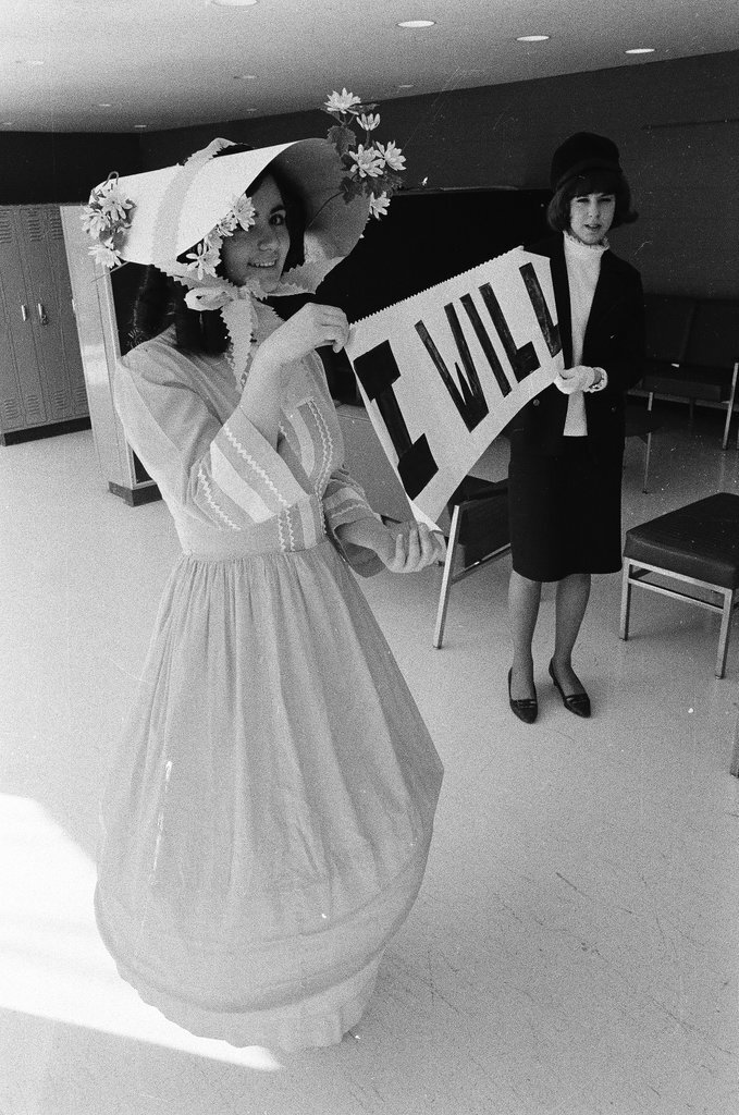 Two students dressed in historical and contemporary costumes holding a banner - Chicago Sun-Times