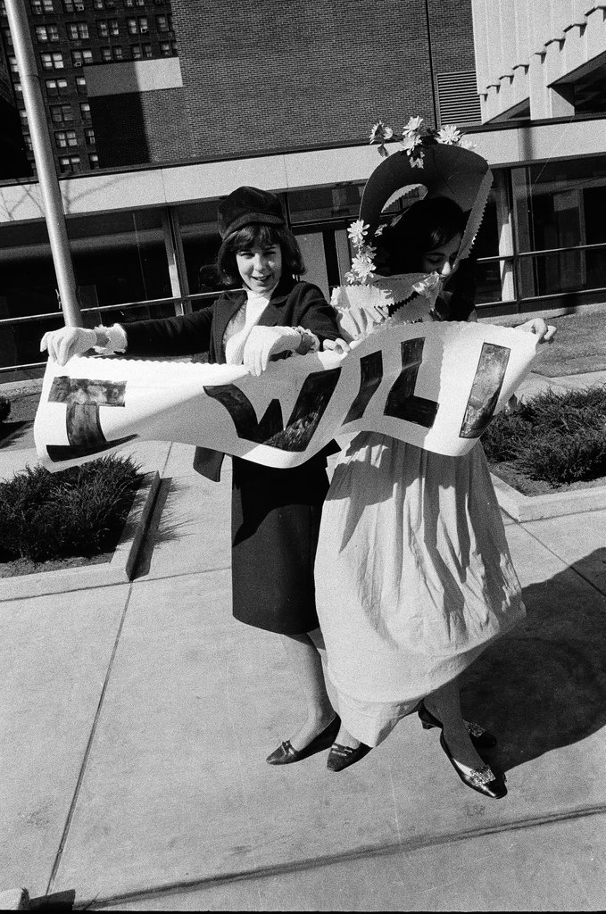 Two students dressed in historical and contemporary costumes holding a banner - Chicago Sun-Times