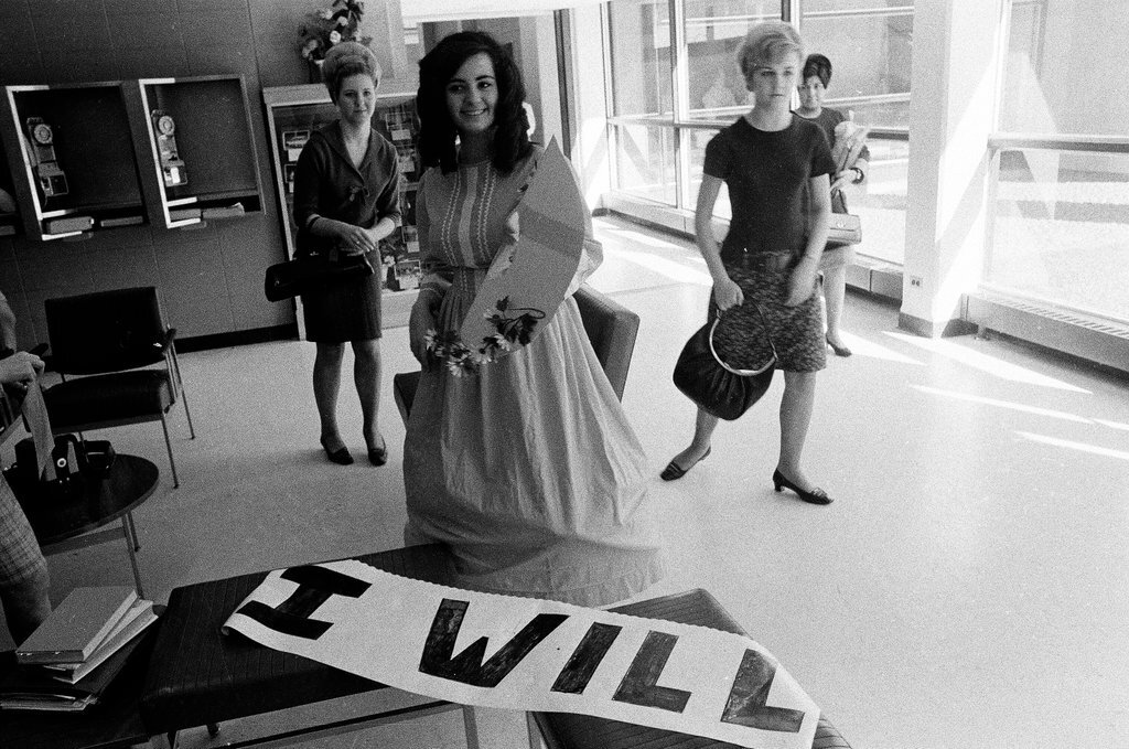 Two students dressed in historical and contemporary costumes holding a banner - Chicago Sun-Times