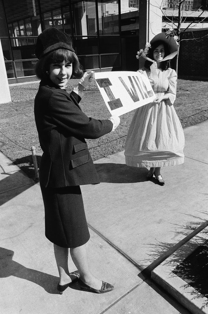 Two students dressed in historical and contemporary costumes holding a banner - Chicago Sun-Times