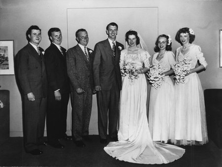 Photograph of Lois Marie (Johnson) Klaas and John Robert Klaas on their wedding day with their wedding party. - Unknown