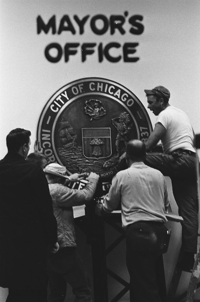 Workmen hang city seal in Mayor's Office - Chicago Sun-Times