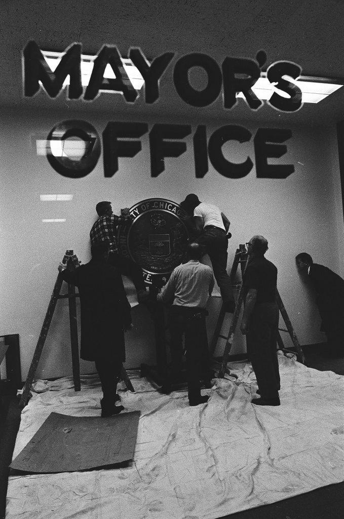 Workmen hang city seal in Mayor's Office - Chicago Sun-Times
