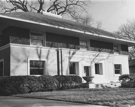 Exterior of a Frank Lloyd Wright designed house- three windows across top of front with intricate detail between - Leroy Mick