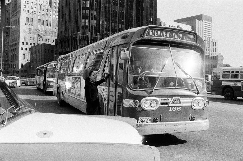 A woman runs to catch a bus on Michigan Avenue - Chicago Sun-Times