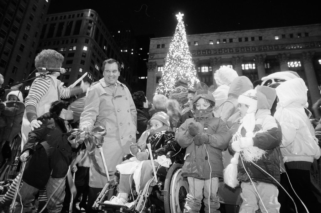 Santa and Mrs. Claus wave to the crowd at Richard J. Daley Plaza after the tree lighting - Chicago Sun-Times