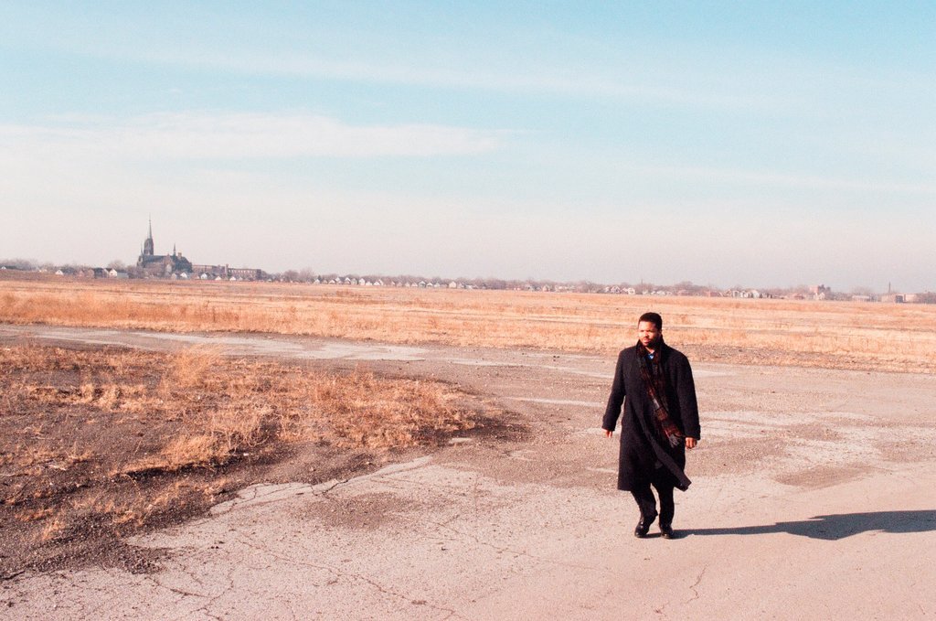 Jesse Jackson, Jr. walks along train tracks with the recently closed South Works steel plant in the background - Chicago Sun-Times