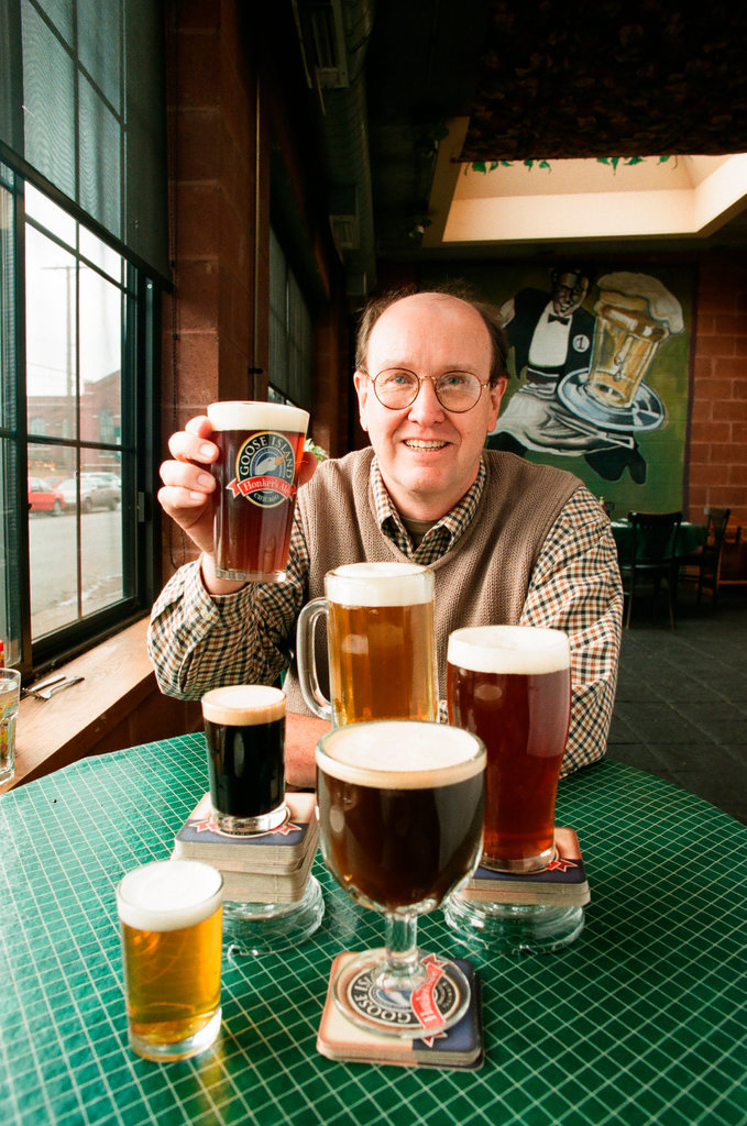 An individual poses with multiple beers brewed and served at the Goose Island Brew Pub - Chicago Sun-Times