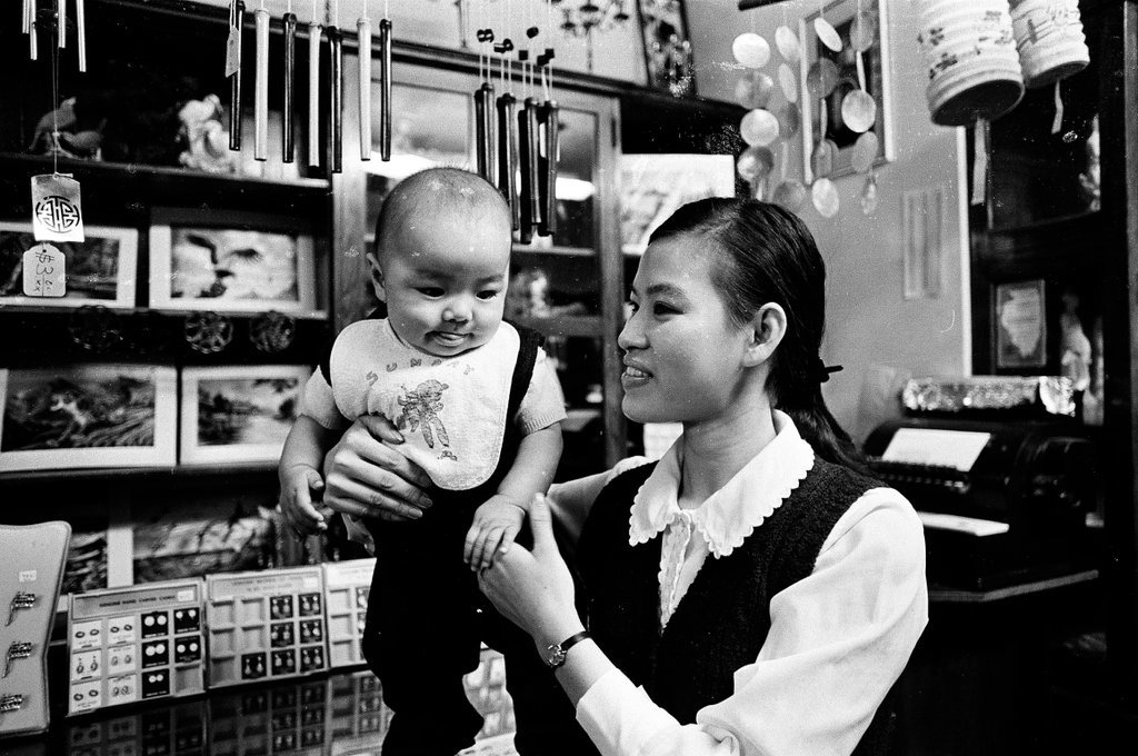 Members of Chicago's Chinese community shop at locally owned businesses and walk along the street while children play outside - Chicago Sun-Times