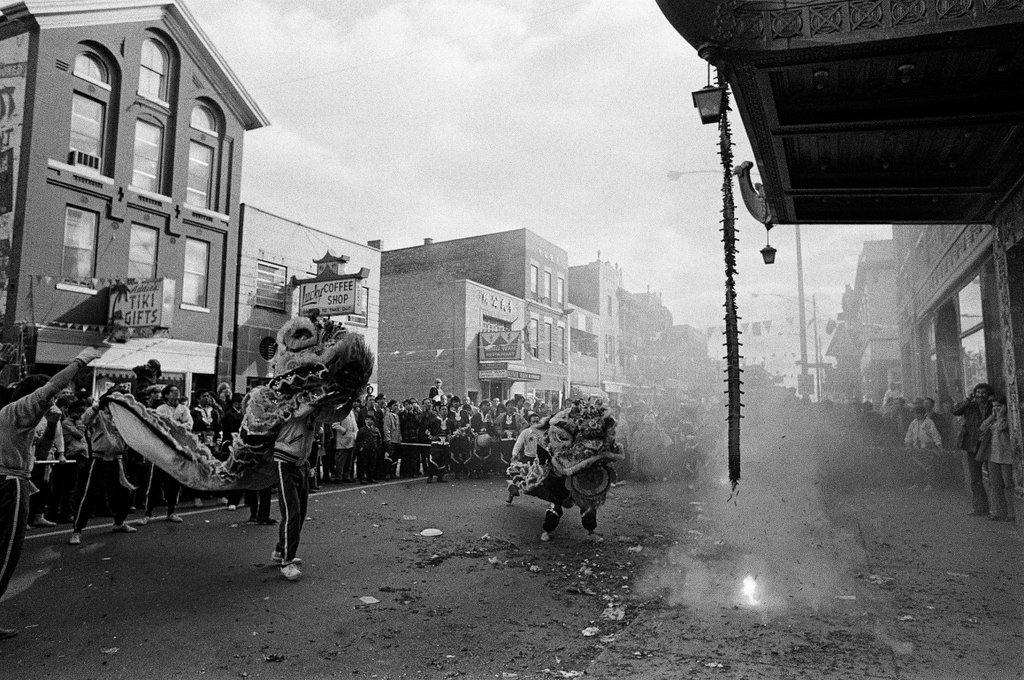 Dragons dance next to firecrackers as the Chicago Chinese Independence Day Parade marches through Chinatown - Chicago Sun-Times