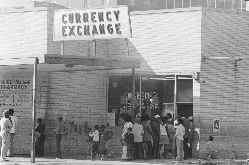 People visit a currency exchange at East Pershing Road and South State Street - Chicago Sun-Times