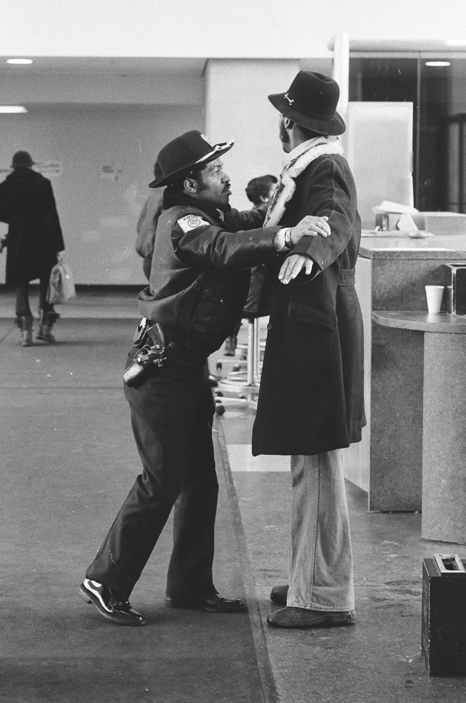 Security officers pat down individuals arriving for John Wayne Gacy's hearing - Richard Derk for Chicago Sun-Times