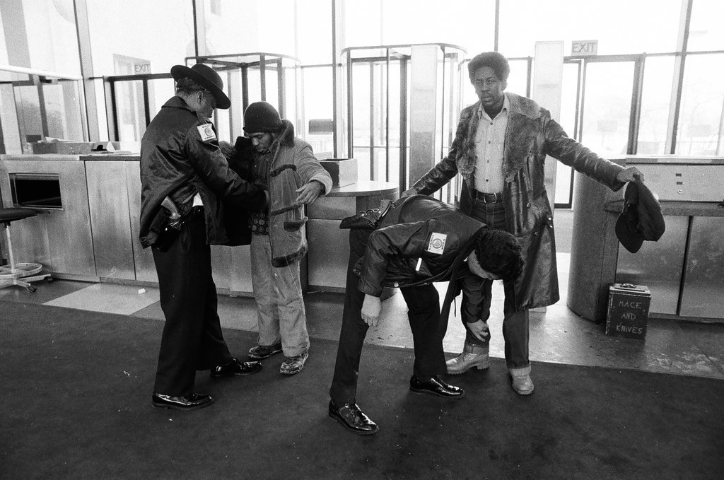 Security officers pat down individuals arriving for John Wayne Gacy's hearing - Richard Derk for Chicago Sun-Times