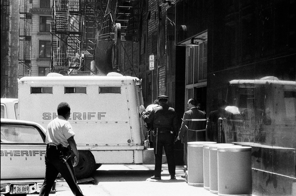 John Wayne Gacy is transferred to a van under heavy security after a brain scan - Gene Pesek for Chicago Sun-Times
