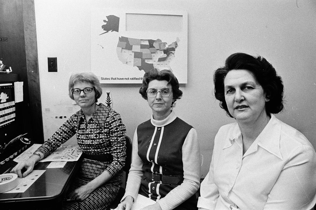 Three women sitting in front of a map showing states yet to ratify ERA - Chicago Sun-Times