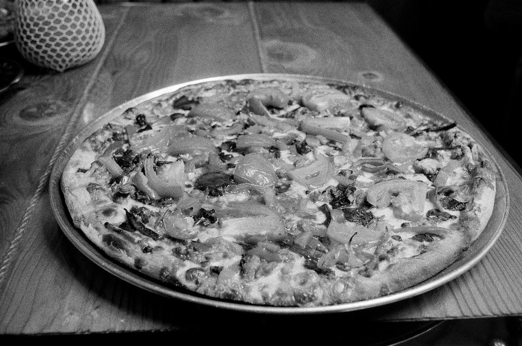 Chef at Chicago Pizza and Oven Grinder Company showing off a pizza - Chicago Sun-Times