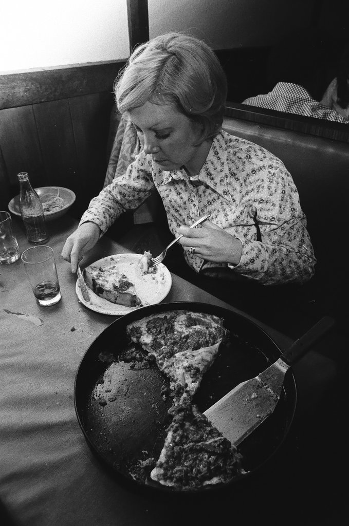 Woman eating deep-dish pizza at Pizzeria Due - Chicago Sun-Times