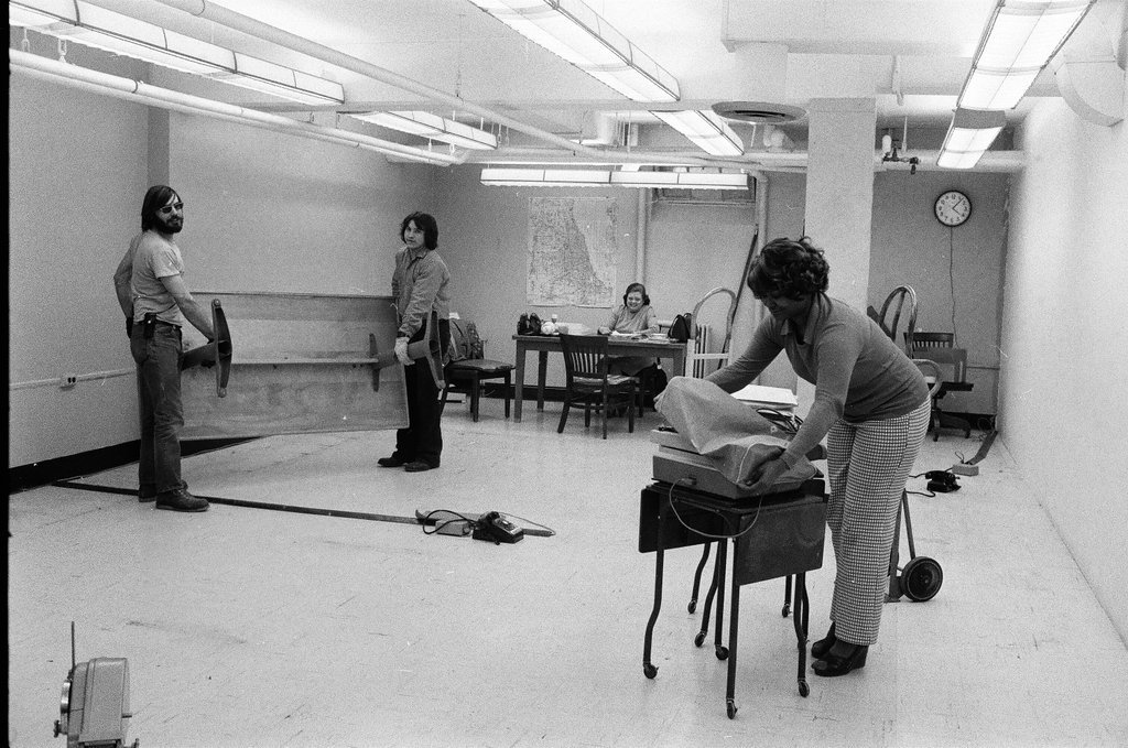 Workers clear out an induction office - Chicago Sun-Times