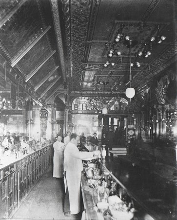 Interior view of Hannah & Hogg Saloon with group of men and three bartenders - Taylor, J. W. (John W.)