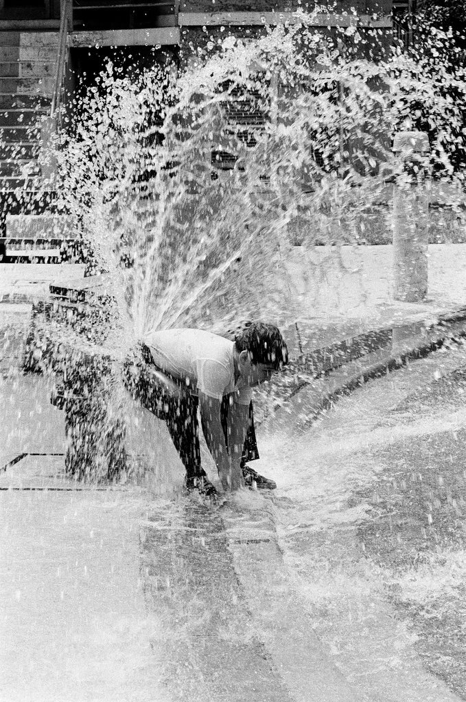 Children play under the spray of an open fire hydrant - Chicago Sun-Times