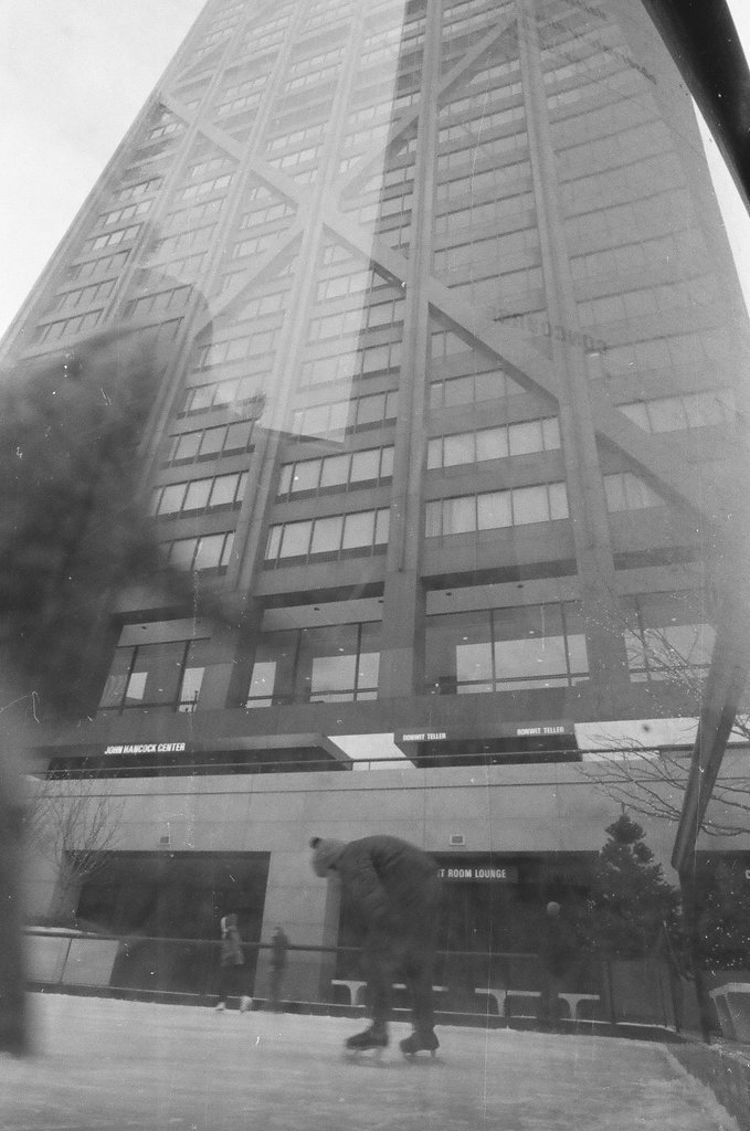 People ice skate at a rink in front of the Hancock Building - Chicago Sun-Times