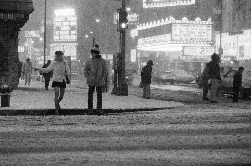 Pedestrians cross the street in the snow along South State Street - Chicago Sun-Times