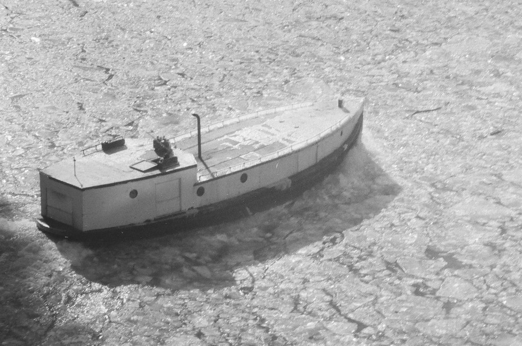 A fishing boat breaks through ice in the Chicago River - Chicago Sun-Times