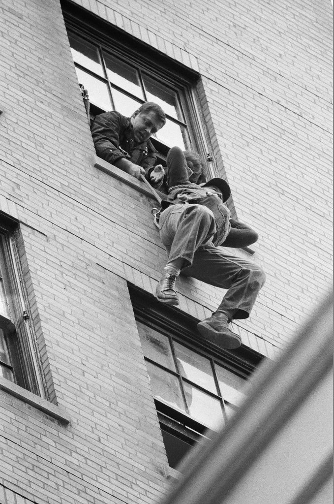 Ray Weich dangles below a twelfth story window while waiting to be rescued - Chicago Sun-Times