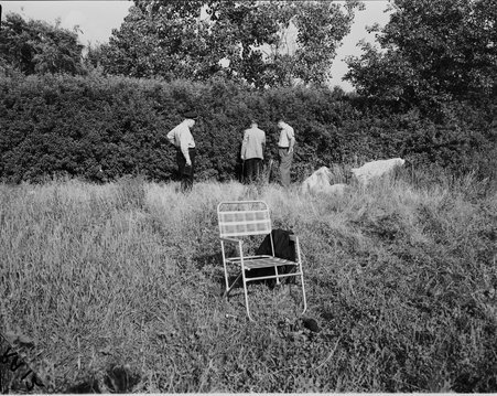 5100 N and Lake Shore: Park District police searching area for purse or other possible identification at murder site. Slain woman's chair is in the foreground. Victim: Margaret Gallagher. - Ralph Arvidson for Chicago Sun-Times