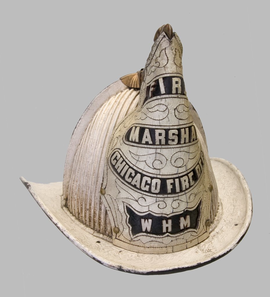 Front view of a Chicago Fire Department fire marshall helmet used during the Chicago Fire of 1871. - Cairns and Bros New York