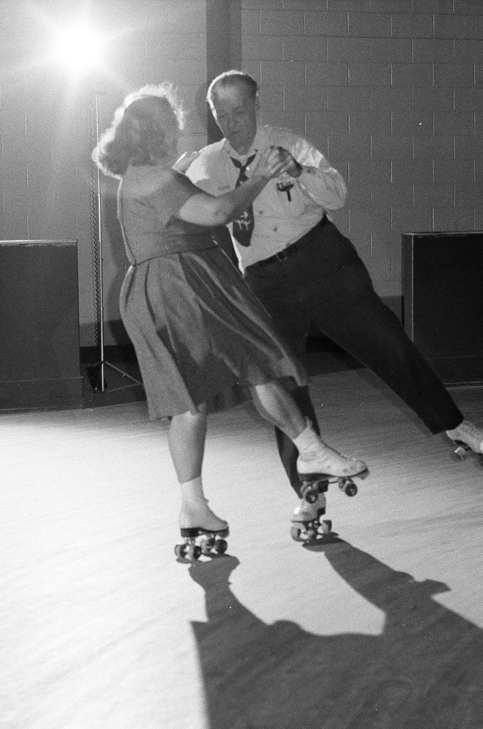 People enjoy roller skating in pairs at an indoor rink - Chicago Sun-Times