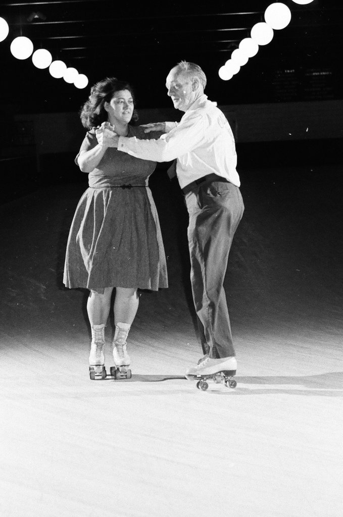 People enjoy roller skating in pairs at an indoor rink - Chicago Sun-Times