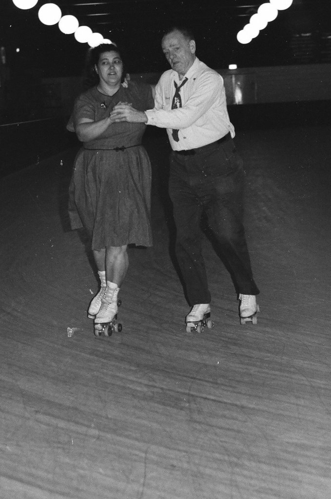 People enjoy roller skating in pairs at an indoor rink - Chicago Sun-Times