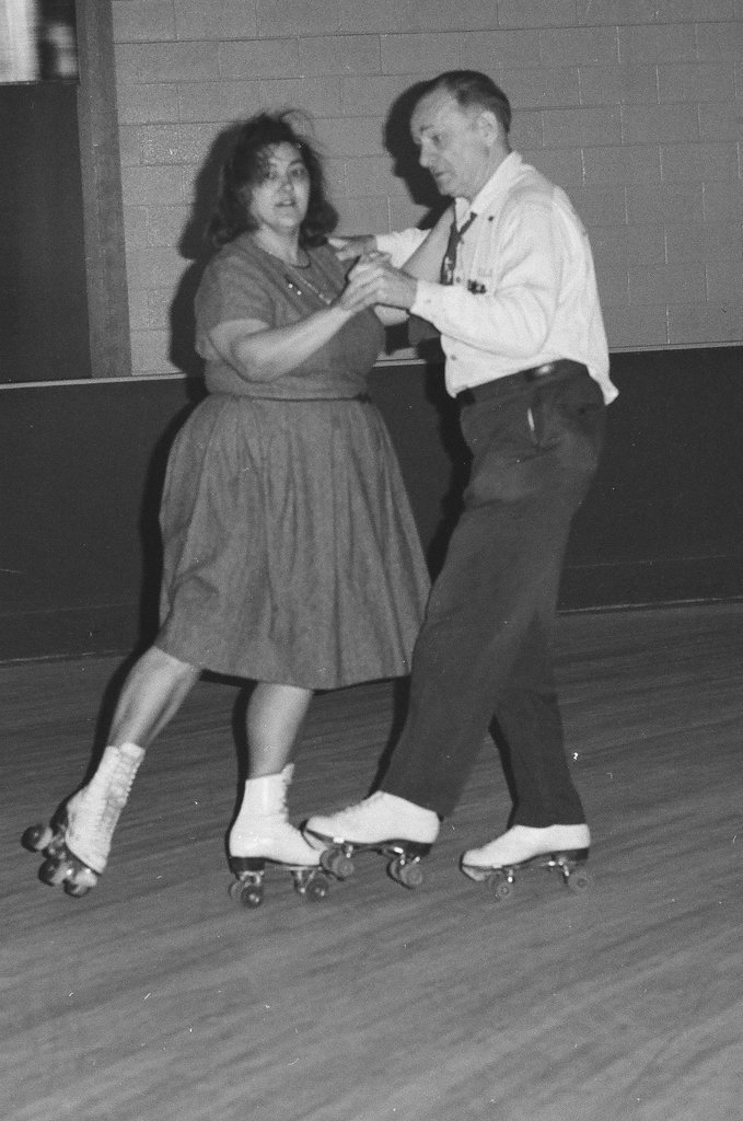 People enjoy roller skating in pairs at an indoor rink - Chicago Sun-Times