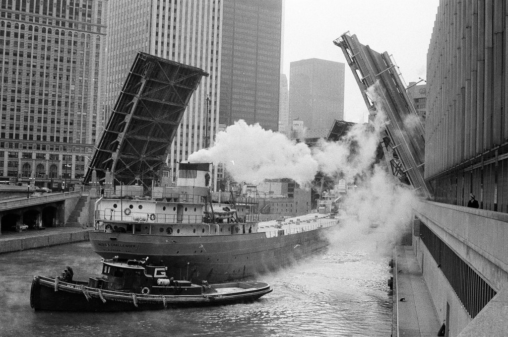 A tug boat tows the Medusa Challenger as it waits for the Wabash Avenue bridge to open - Howard Lyon for Chicago Sun-Times