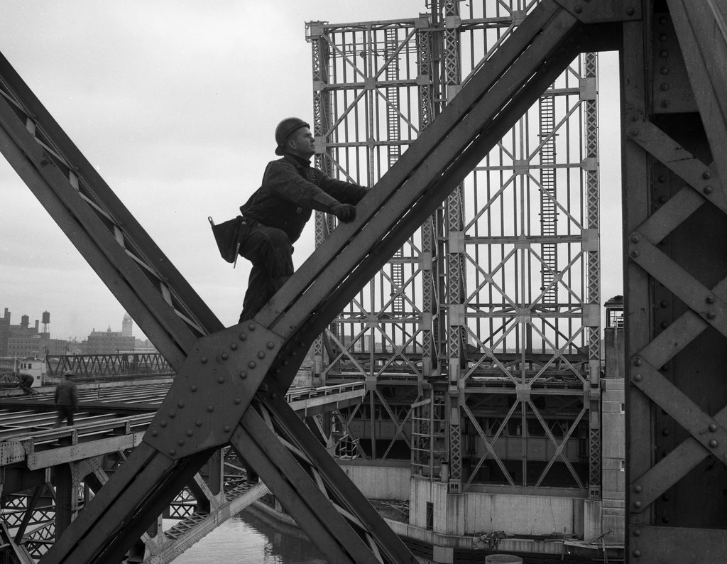 Worker climbing bridge over Chicago River - Chicago Sun-Times